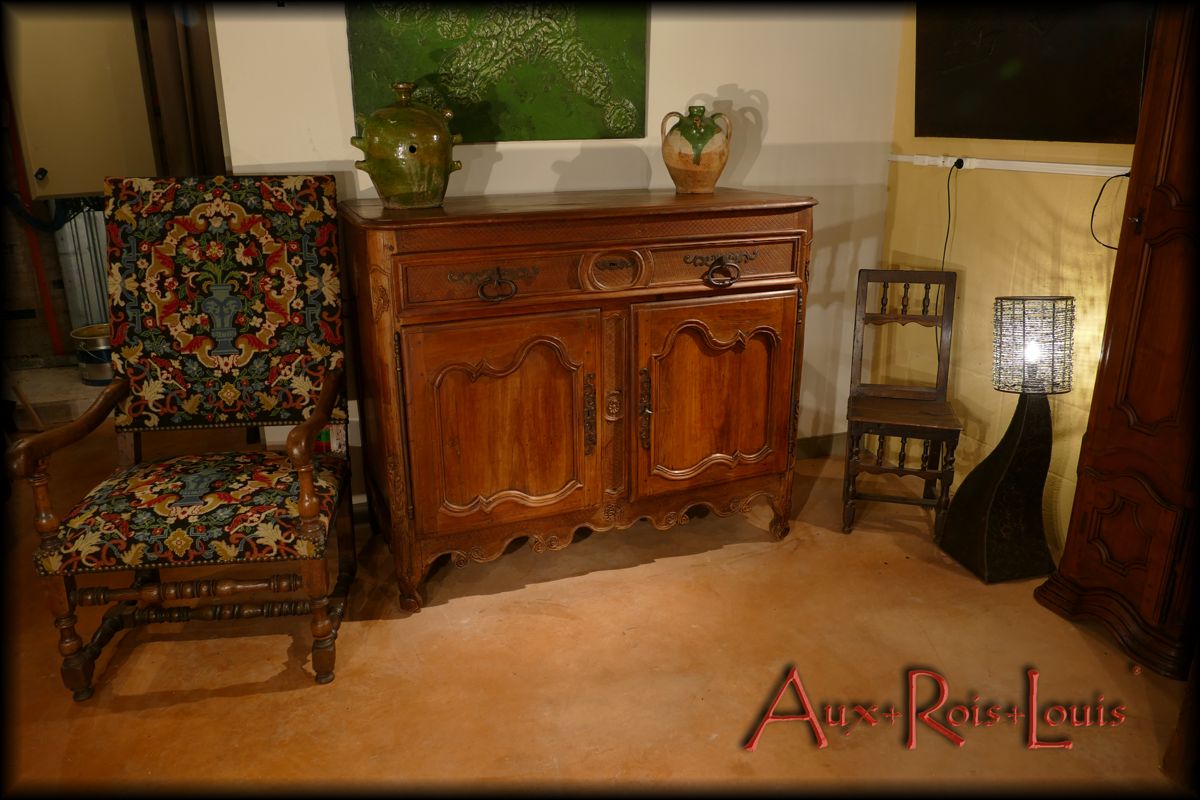 This cherry wood sideboard combines rich and well-organized moldings typical of the Louis XV Regency style and fantasy of the furniture carpenter who shaped it.