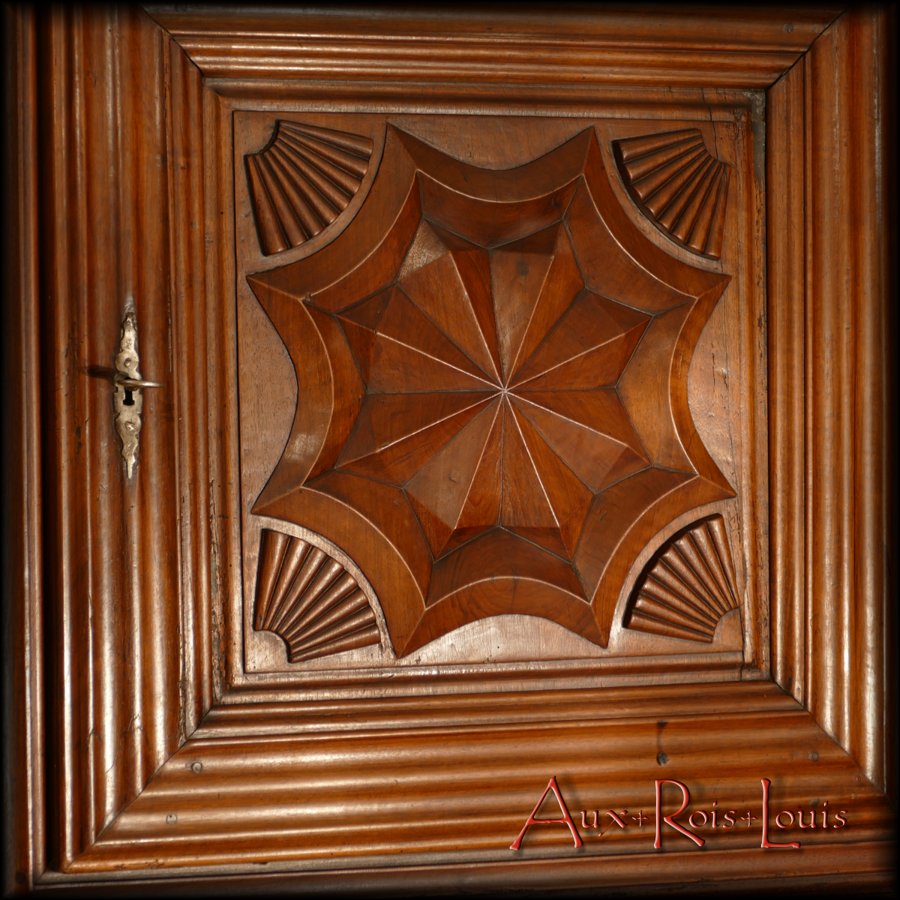 Compass rose pattern framed by stylized shells on the top door