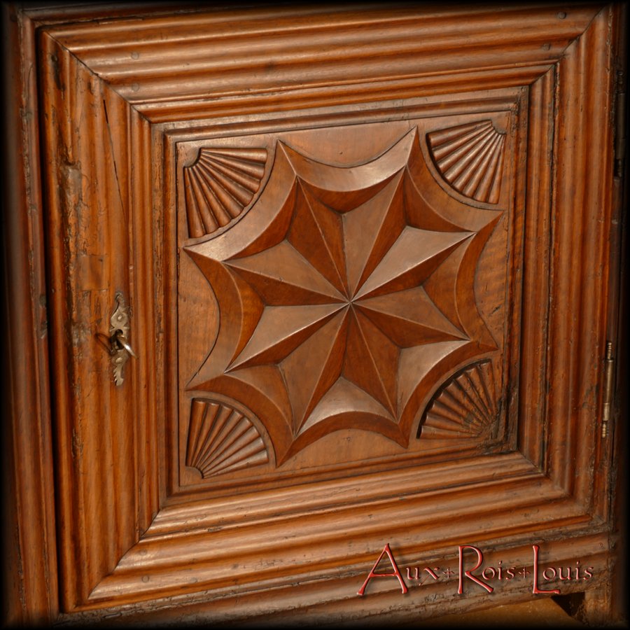 Compass rose pattern framed by stylized shells on the bottom door