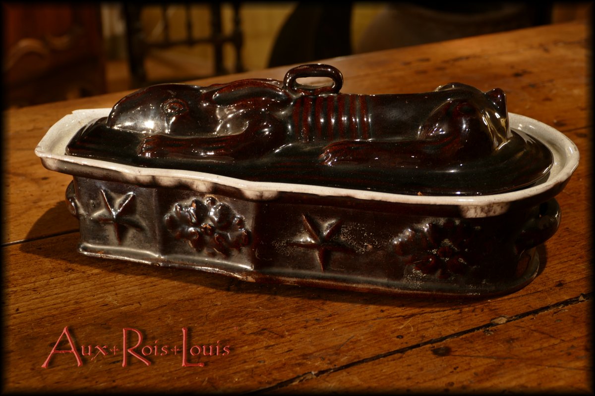 Adorned with stars and floral motifs, this glazed terrine was used for cooking and presenting the famous hare pâté.