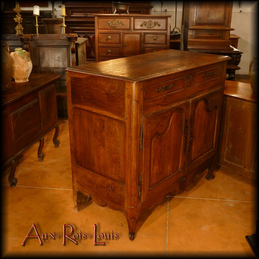 The sides of this surprising sideboard are elegantly paneled and scalloped.