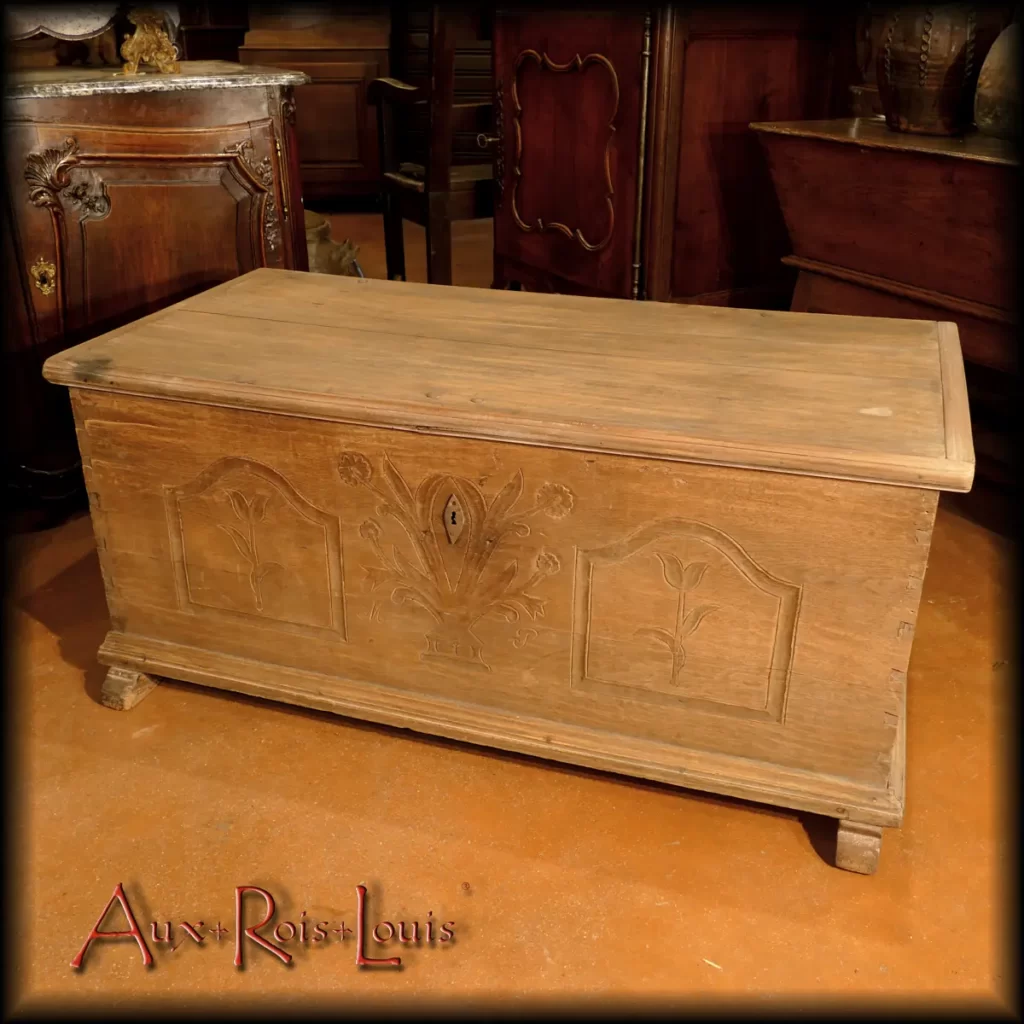 Offered as part of the bride's dowry by her father, this natural oak chest adorned with tulips and a country bouquet served two purposes in the 18th century: to hold the personal effects of the young bride and to allow the couple to sit at the foot of their bed in complete intimacy. Hence its name 